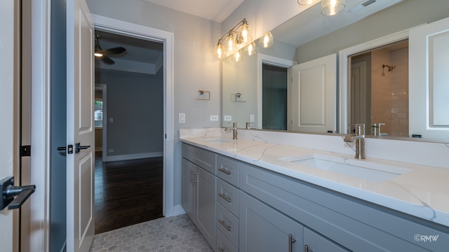 bathroom featuring vanity, tiled shower, ceiling fan, and tile patterned flooring