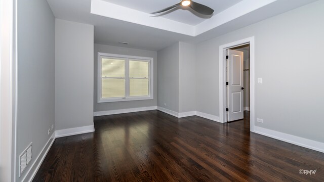 unfurnished room with ceiling fan and dark hardwood / wood-style flooring