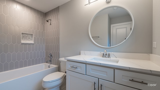 full bathroom featuring toilet, tiled shower / bath combo, and vanity