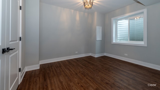 spare room with dark hardwood / wood-style floors