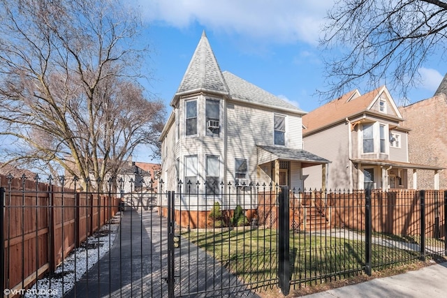 victorian home featuring a fenced front yard, a gate, and roof with shingles