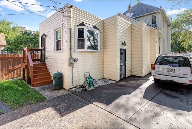 view of property exterior with a wooden deck