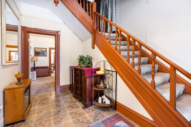 staircase with radiator heating unit and carpet