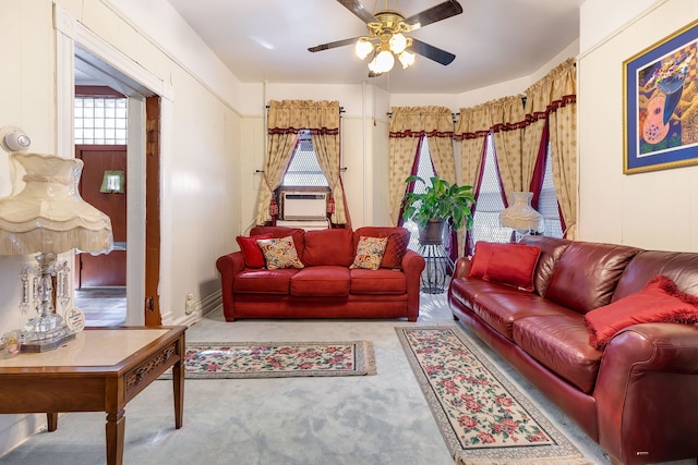 carpeted living room with ceiling fan and cooling unit