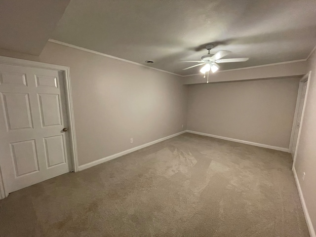 unfurnished room featuring ceiling fan, ornamental molding, and carpet floors