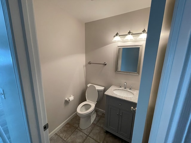 bathroom with vanity, toilet, and tile patterned floors