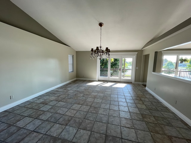 unfurnished dining area featuring french doors, a notable chandelier, a healthy amount of sunlight, and lofted ceiling