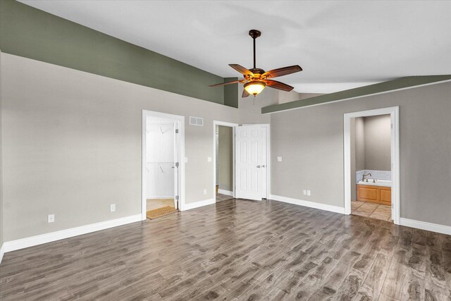 kitchen with white fridge, sink, light stone countertops, and light wood-type flooring