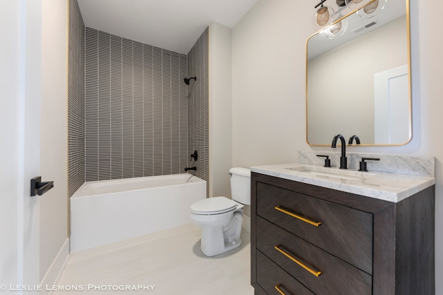 full bathroom with tiled shower / bath combo, vanity, tile patterned floors, and toilet