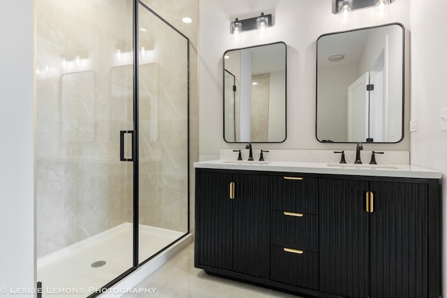 bathroom with a shower with door, tile patterned floors, and double sink vanity