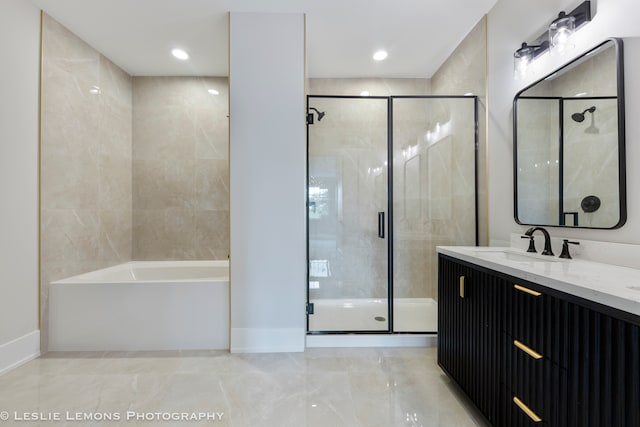 bathroom featuring plus walk in shower, vanity, and tile patterned floors