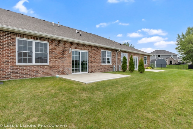 back of house featuring a patio and a lawn