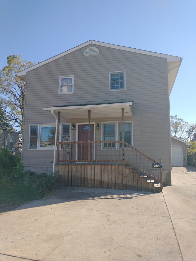 view of front of home featuring covered porch and a garage