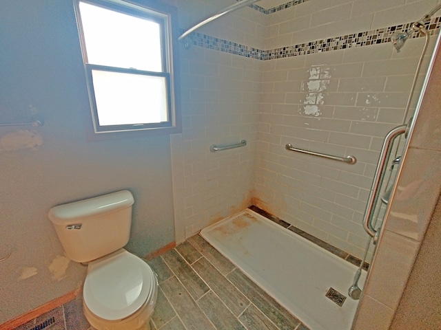 bathroom featuring toilet and an enclosed shower