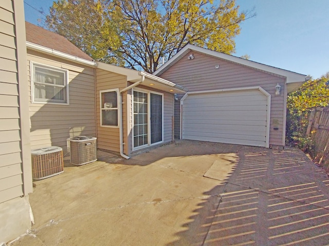 exterior space with a garage and central air condition unit