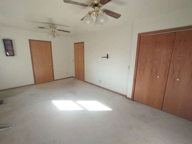 unfurnished bedroom featuring light carpet and ceiling fan