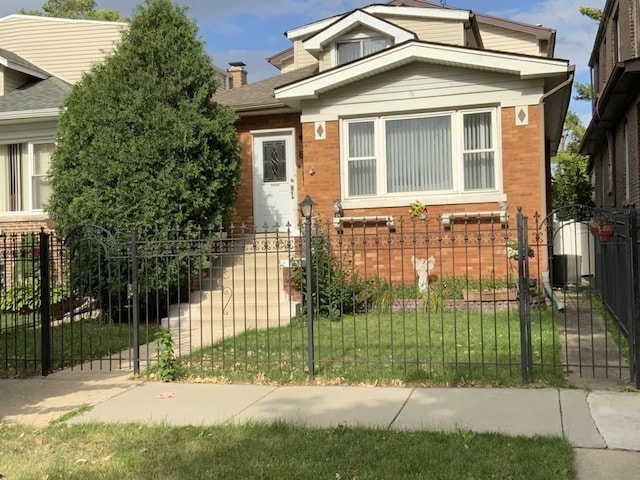 2323 N Keating Ave, Chicago, IL 60639 - bungalow-style house with a fenced front yard, brick siding, central AC, and a gate