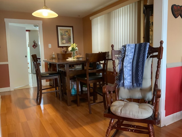 dining space with wood-type flooring