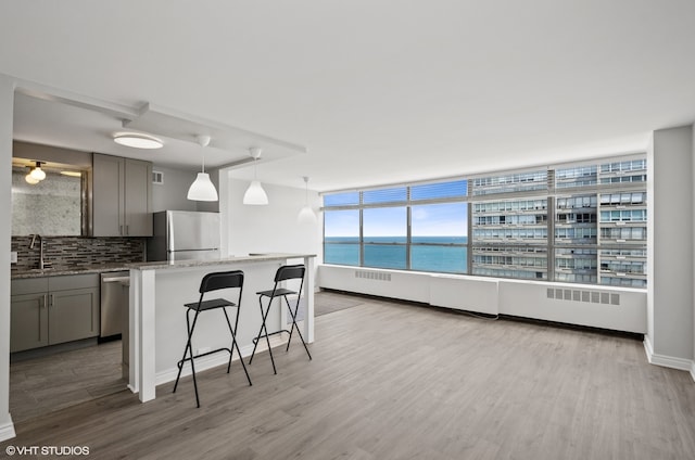 kitchen featuring light hardwood / wood-style floors, sink, gray cabinets, and stainless steel appliances