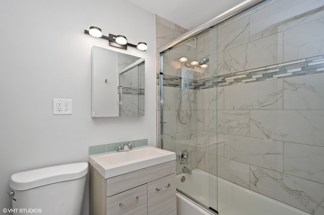 full bathroom with vanity, combined bath / shower with glass door, and toilet