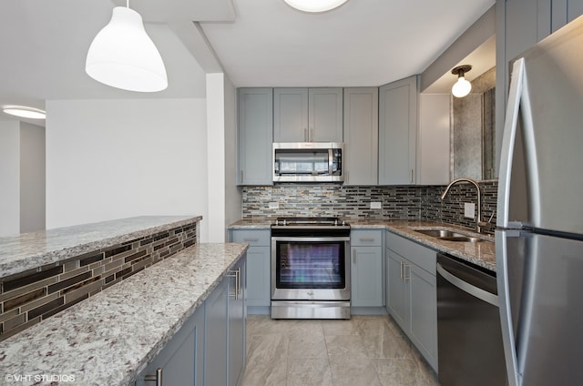 kitchen featuring appliances with stainless steel finishes, tasteful backsplash, sink, light stone countertops, and light tile patterned flooring