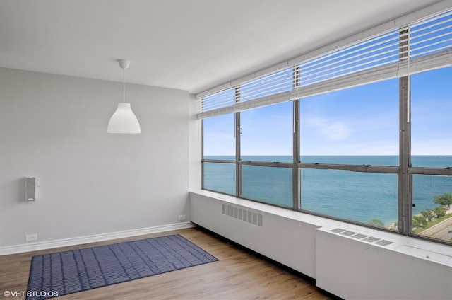 unfurnished sunroom with a water view