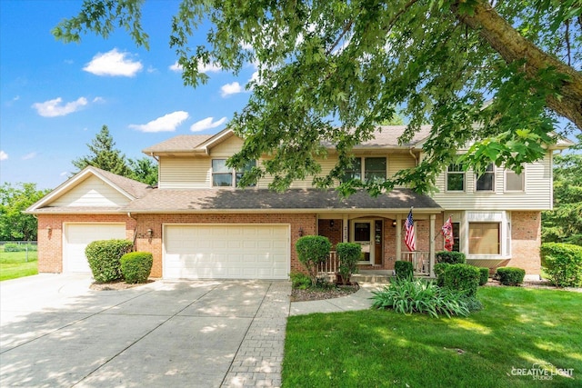 view of front facade with a front yard, an attached garage, brick siding, and driveway