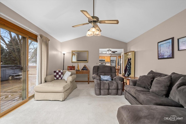 living area with light colored carpet, lofted ceiling, and ceiling fan