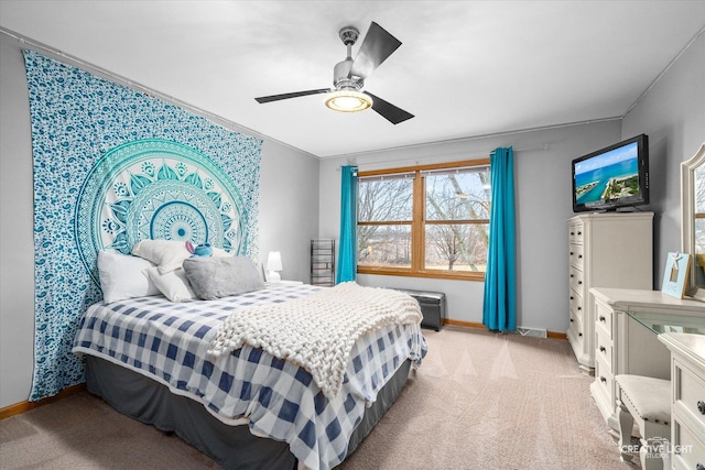 bedroom featuring baseboards, light colored carpet, and a ceiling fan