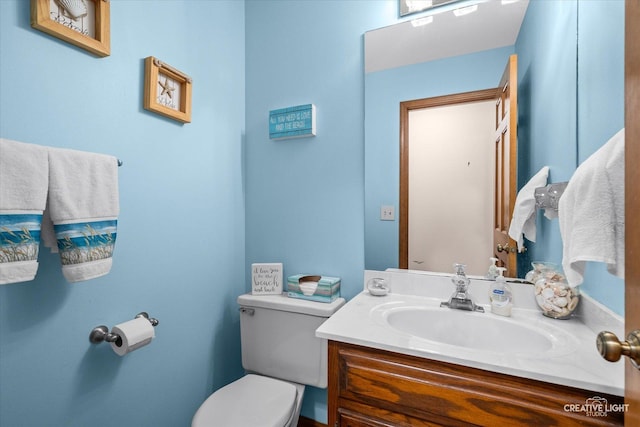 bathroom with toilet and vanity