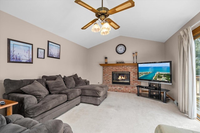 living room with a fireplace, a ceiling fan, carpet, and vaulted ceiling