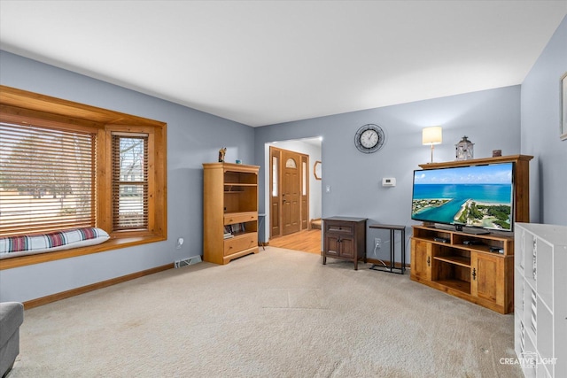 carpeted living room with visible vents and baseboards