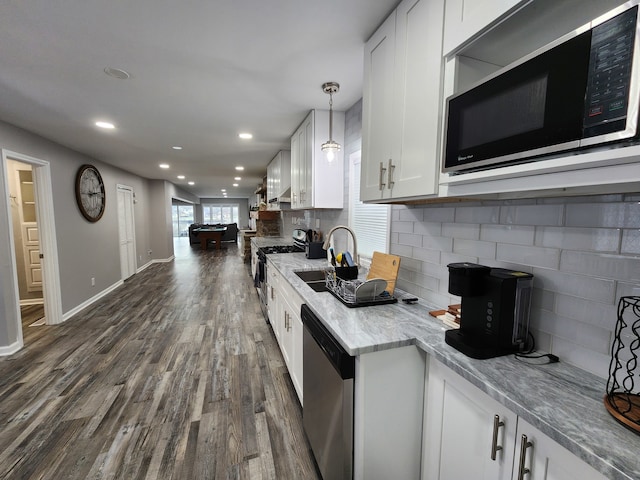 kitchen featuring sink, appliances with stainless steel finishes, dark wood-type flooring, and white cabinets