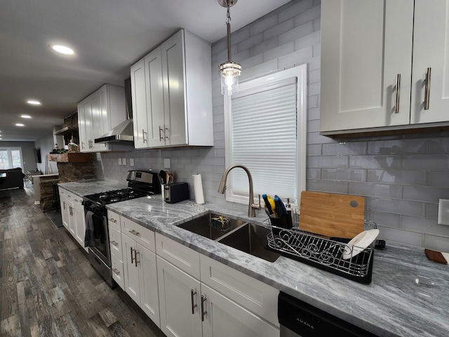 kitchen featuring white cabinets, dark hardwood / wood-style floors, gas stove, and pendant lighting