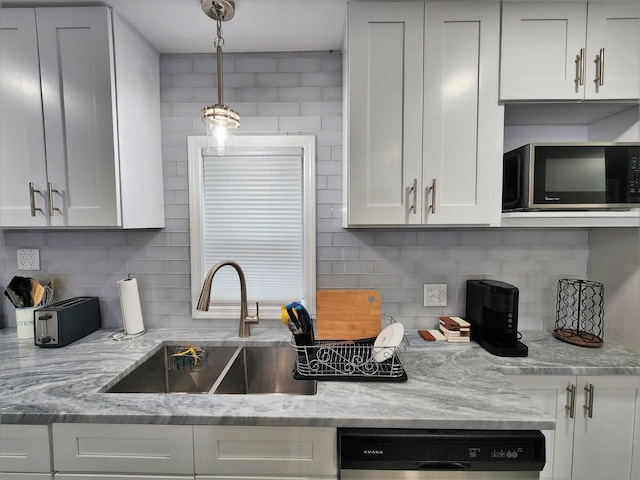 kitchen with light stone counters, white cabinets, black appliances, and tasteful backsplash