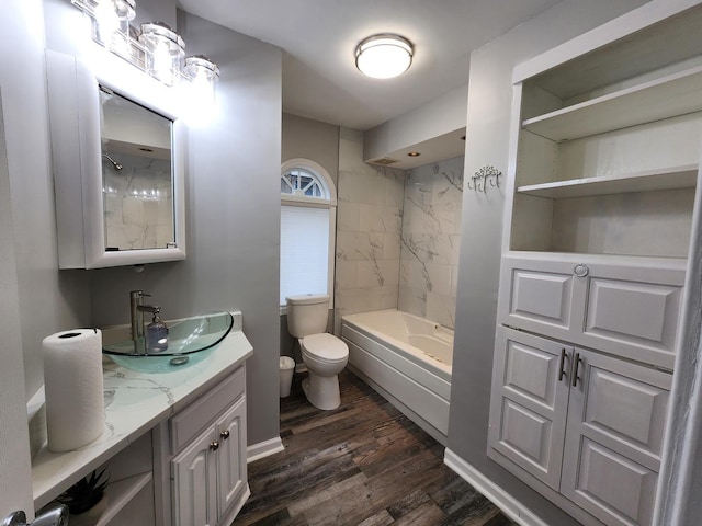 full bathroom with shower / bathtub combination, vanity, wood finished floors, and toilet