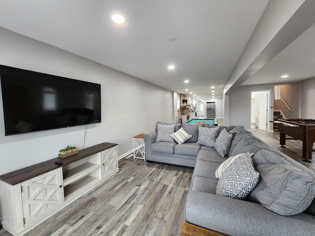 living room featuring light hardwood / wood-style floors and pool table