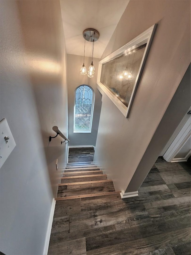 staircase with wood finished floors and baseboards