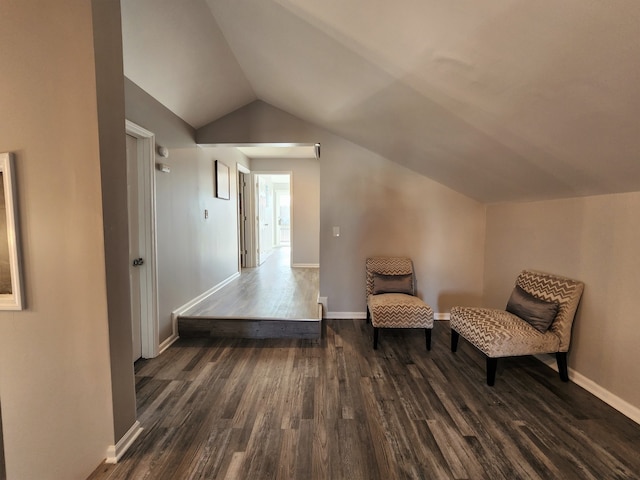 living area featuring vaulted ceiling and hardwood / wood-style floors