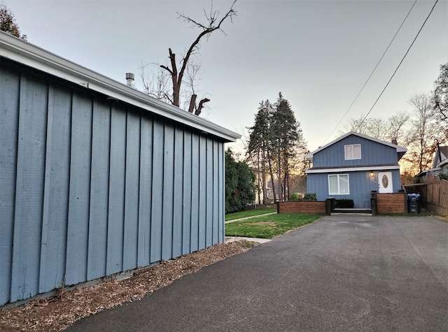 view of home's exterior featuring a lawn and board and batten siding