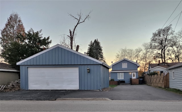 view of garage at dusk