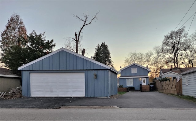 detached garage featuring fence