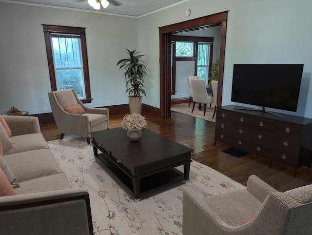 living room with hardwood / wood-style floors, plenty of natural light, ceiling fan, and crown molding