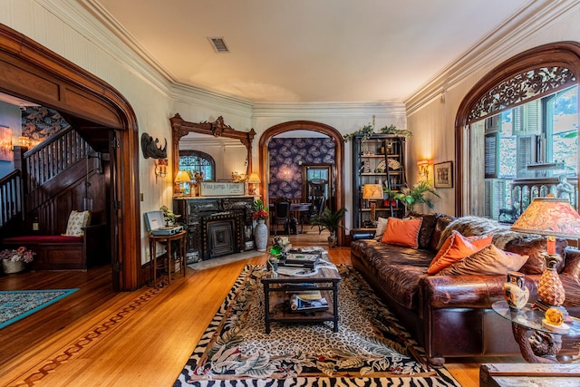 living room featuring crown molding and wood-type flooring