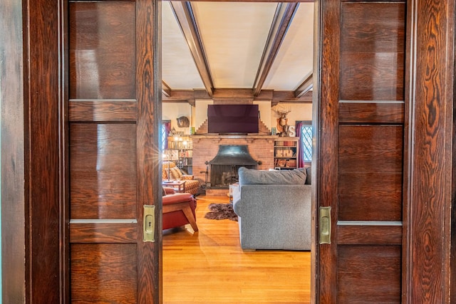 living room featuring beamed ceiling and wood-type flooring