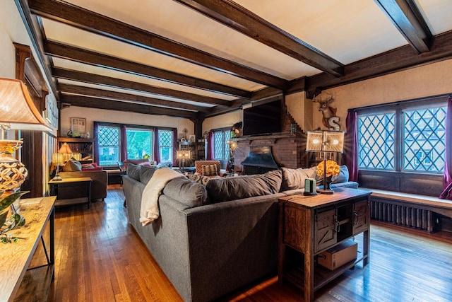 living room with dark hardwood / wood-style floors and beamed ceiling