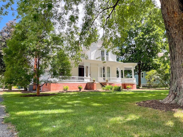 view of front of home featuring covered porch and a front lawn