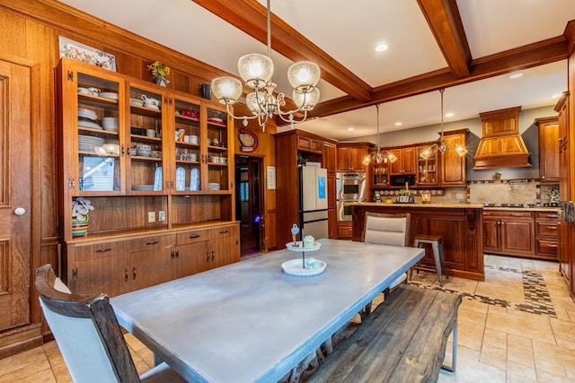 dining space featuring beam ceiling and a chandelier