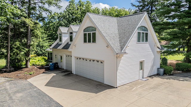 view of side of home featuring a garage