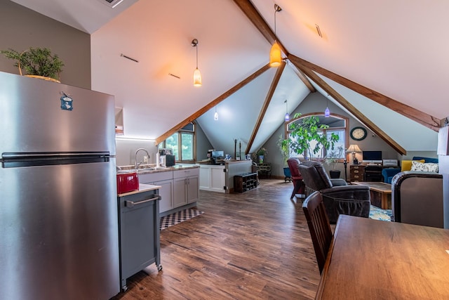 interior space with sink, dark hardwood / wood-style floors, and lofted ceiling with beams